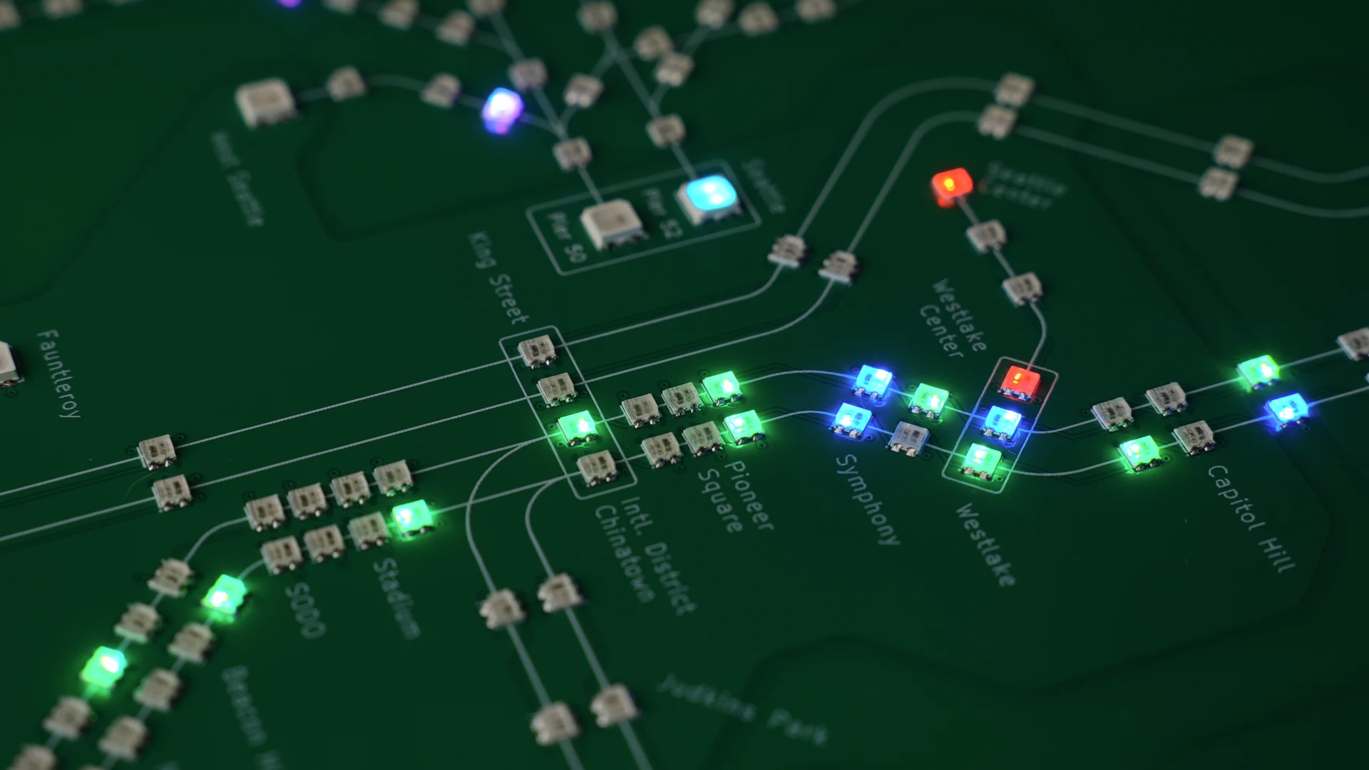 Close-up of green, blue, and red LEDs illuminating the Seattle Transit Live circuit board